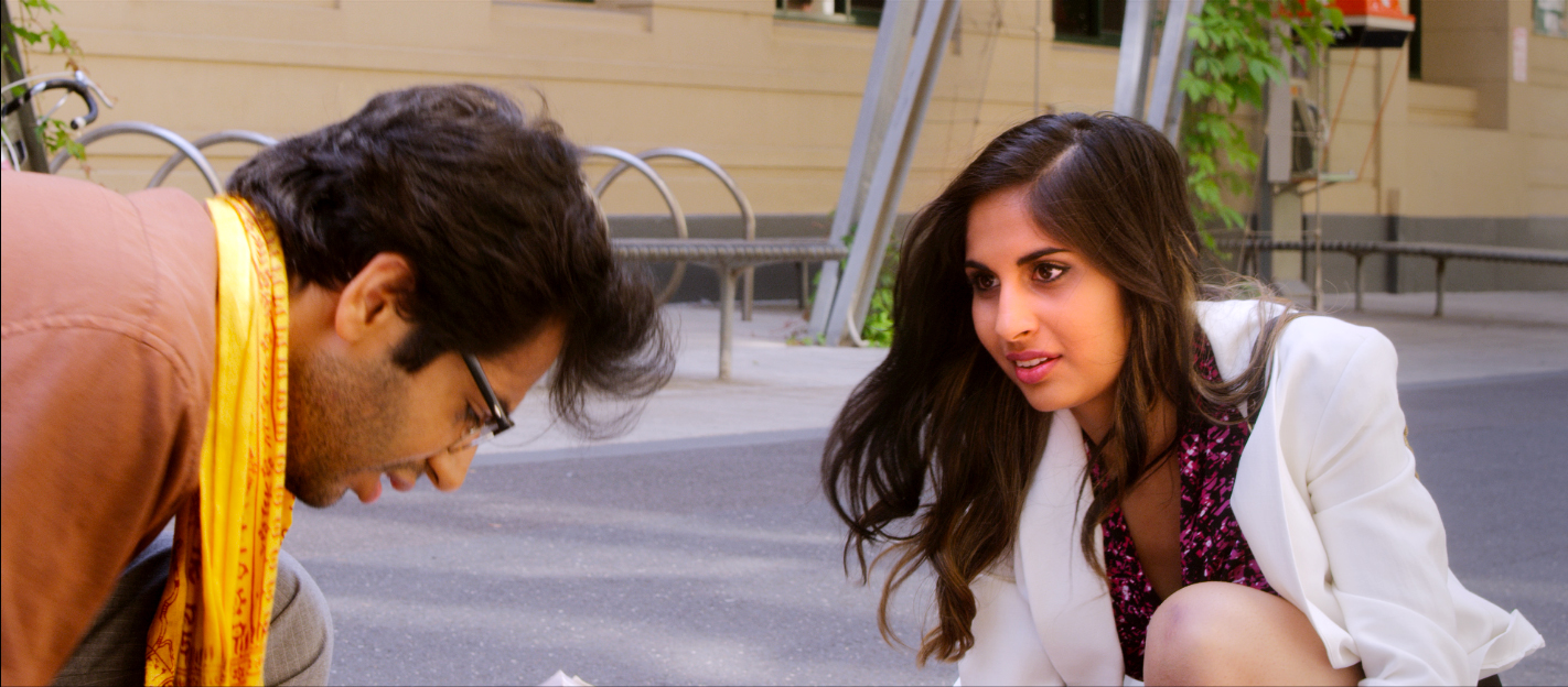Maria and Giriraj in a street-level scene